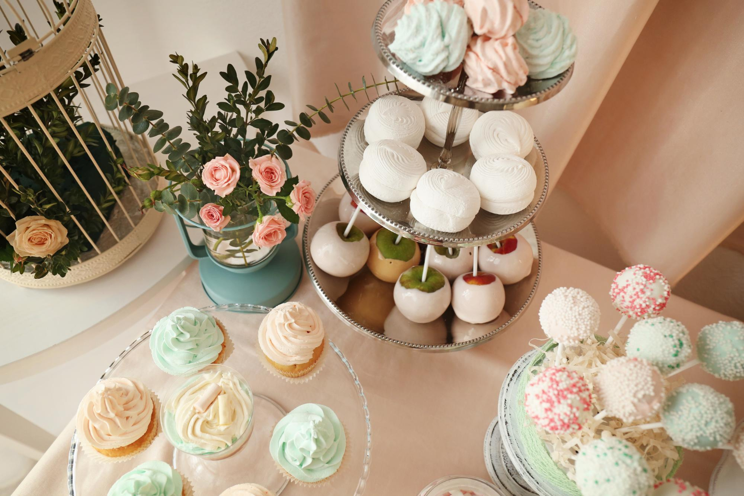 Slice ofCake and Cake Popswith creamy frosting on a white plate